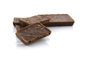 Closeup detail of chocolate parts on white background.