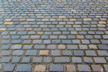 Old grey pavement of cobble stones in a circle pattern