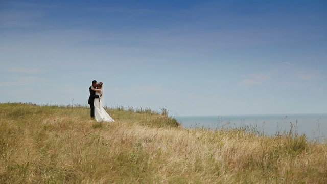 Wedding Couple Standing Against Blue Sky