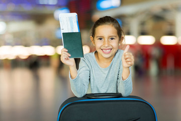 little girl giving thumb up at airport