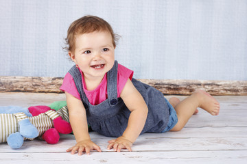 Naklejka premium Happy little child playing on the floor