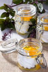Little mason jar with dessert of creme and peach