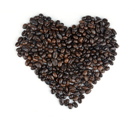 Roasted coffee beans in the shape of the heart.