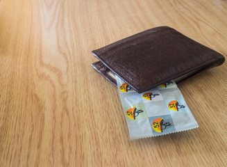 condoms in brown wallet