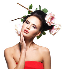 Fototapeta premium Portrait of beautiful young woman with flowers in hair.