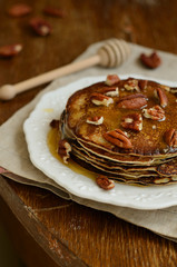 Homemade thin pancakes with honey and pecan nuts on white porcel - 68555119