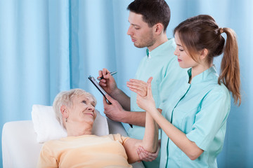 Physiotherapists diagnosing patient