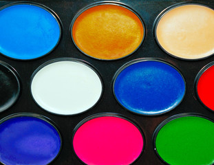 Watercolor paints in a box close up as background