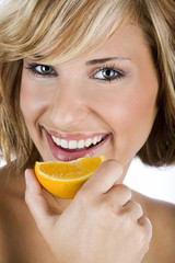 Sexy women holding fresh orange, promoting healthy lifestyle