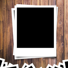 blank photo frame on brown wood plank background