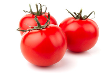 three fresh tomatoes isolated on white background
