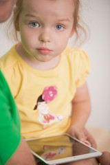 Father and child using electronic tablet at home