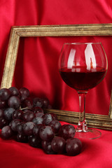 composition of frame,wine and grapes on bright background