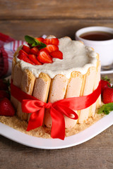 Tasty cake Charlotte with fresh strawberries on wooden table