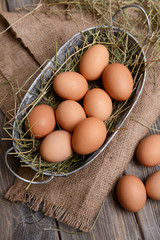 Eggs in wicker basket on table close-up