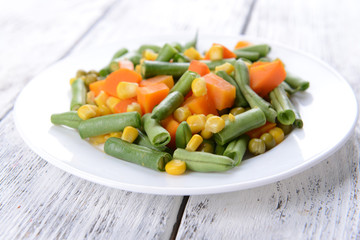 Delicious vegetables salad on plate on table close-up