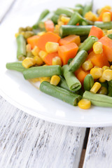 Delicious vegetables salad on plate on table close-up