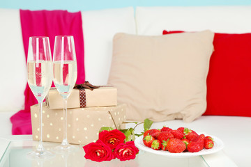 Romantic still life with champagne, strawberry and roses in
