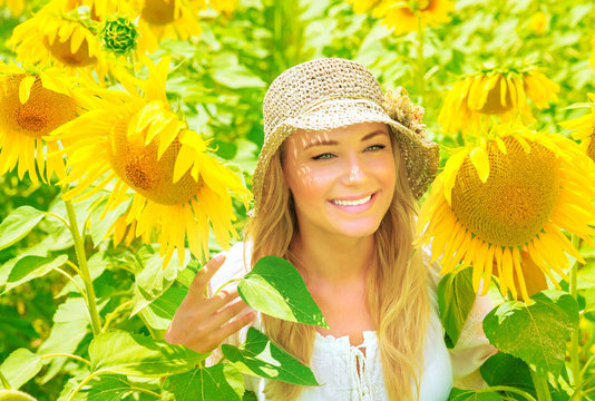 Cute Girl In Sunflower Field