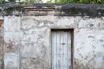 Fototapeta na wymiar Old door on the old wall.
