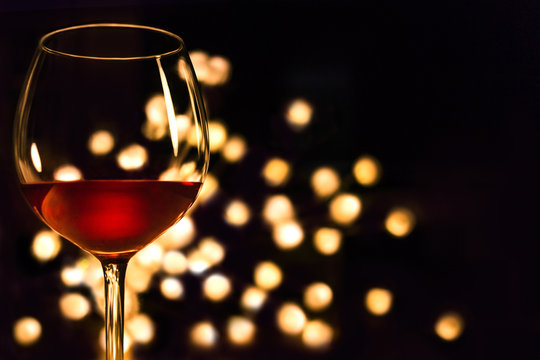 Red wine glass. Christmas romantic dinner image.