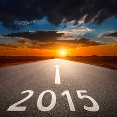 Driving on an empty asphalt road to upcoming 2015