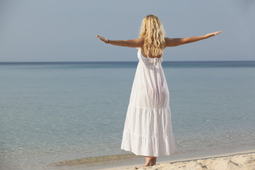 woman practicing yoga on the beach