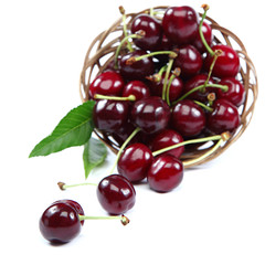 Fresh cherries in a wooden wicker basket.