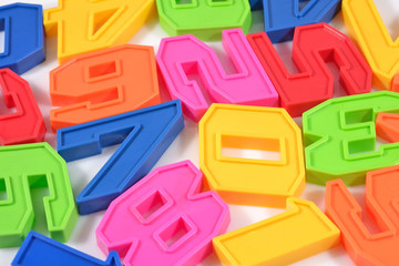 Fototapeta premium Colorful plastic numbers close up on a white