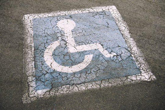 Weathered Disabled Sign in Parking Lot