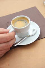 Man holding espresso cup