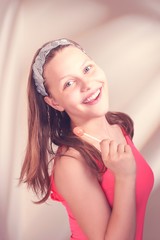 Happy teen girl holding lollipop