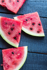 juicy, sweet slices of watermelon  on a dark wooden background
