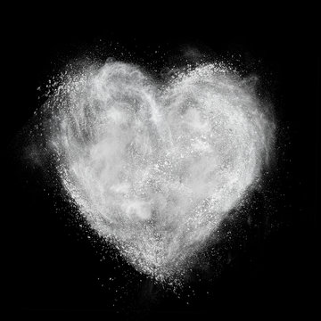 heart made of white powder explosion isolated on black