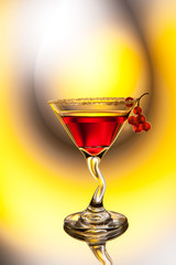 Red cocktail decorated with berries