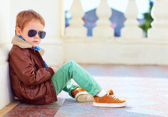 cute stylish boy in leather jacket and gum shoes
