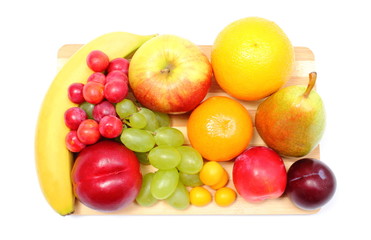 Fresh ripe fruits on wooden cutting board