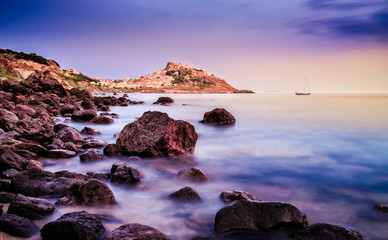 Ocean coastline with village in the background at sunrise