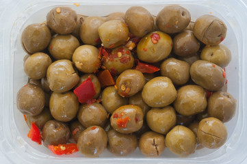 plastic container of marinated olives