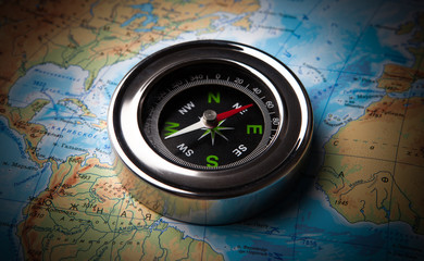 Fototapeta na wymiar tourist compass lying on a map
