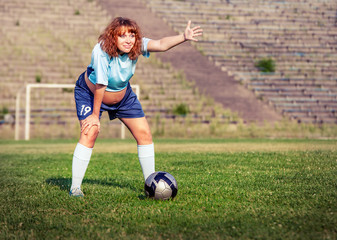 Active pregnant woman playing football