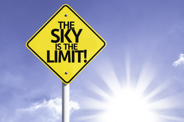 The Sky Is The Limit road sign with sun background