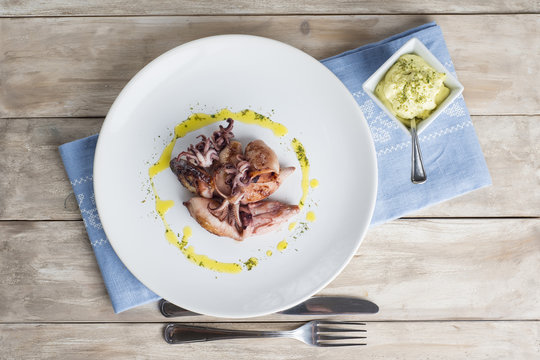 Plato cocinado de calamares a la plancha con salsa alioli 