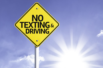 No Texting and Driving road sign with sun background