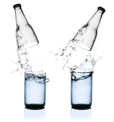 Fresh water splashing out of bottle, isolated on white backgroun