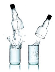 Fresh water splashing out of bottle, isolated on white backgroun