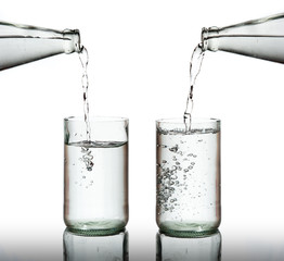 Cold water bottle pour water to glass on white background