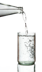 Cold water bottle pour water to glass on white background