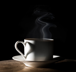 Coffee love. Warm cup of coffee on black background