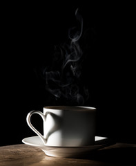 Coffee love. Warm cup of coffee on black background